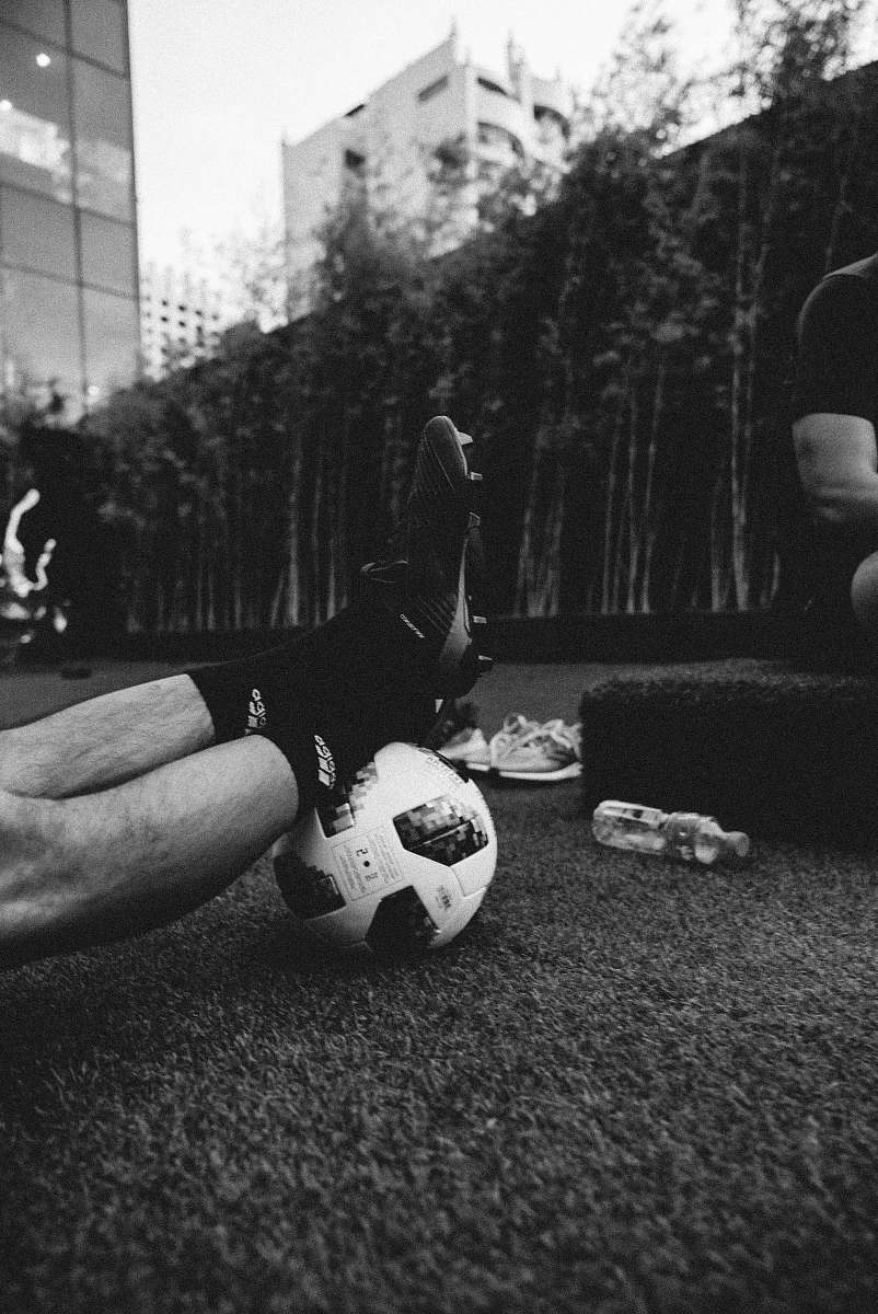 football-gray-scale-photo-of-a-person-s-feet-on-a-football-soccer-image