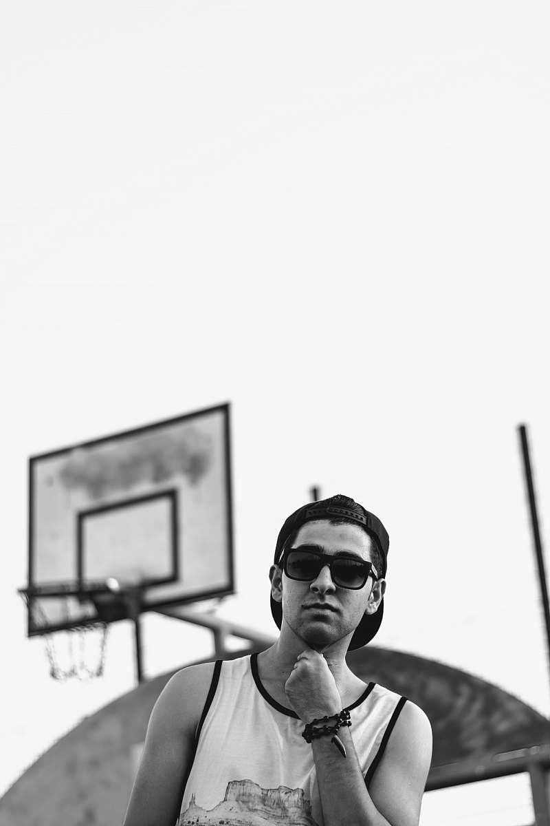 human grayscale photo of man wearing tank top person