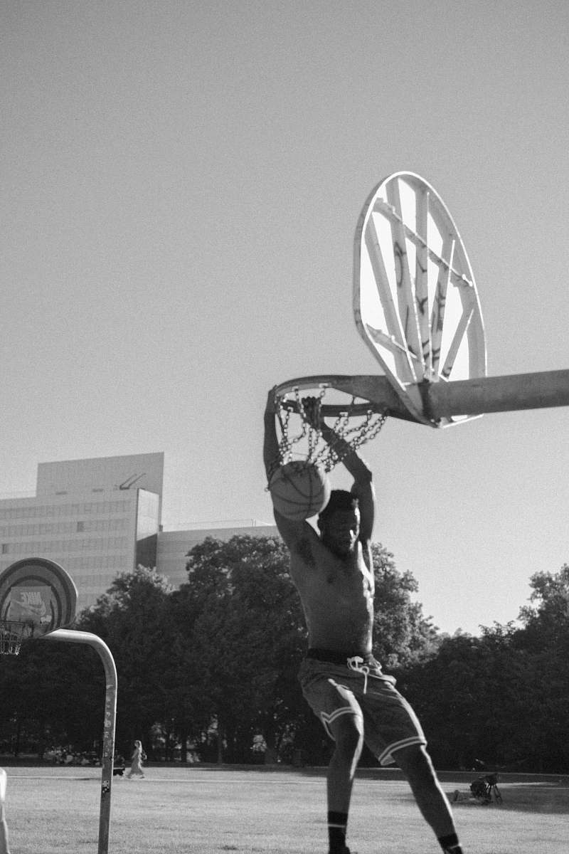 human grayscale photography of man playing basketball person