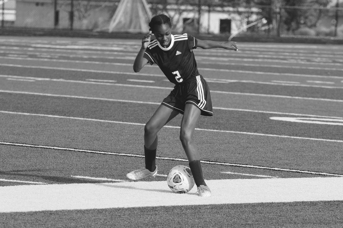 apparel grayscale photography of woman playing soccer clothing