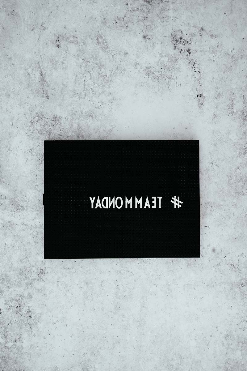 marketing #team monday text overlay on black background social