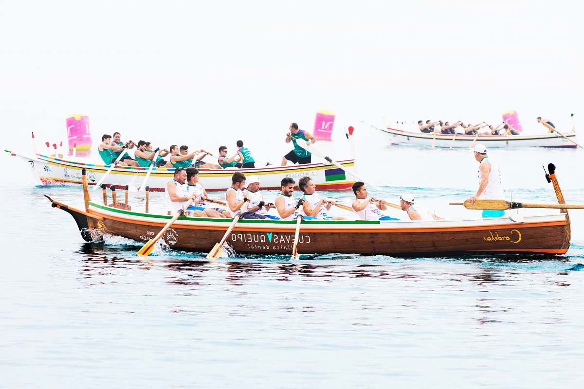 transportation group of people rowing boat vessel
