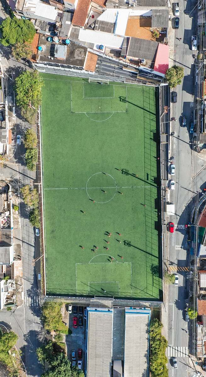 field aerial view of people playing football on court during daytime grey