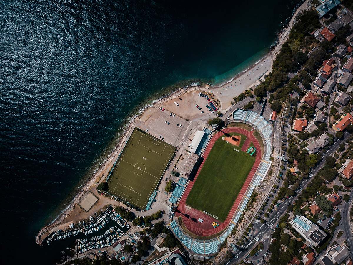 arena top view photography of buildings and body of water stadium