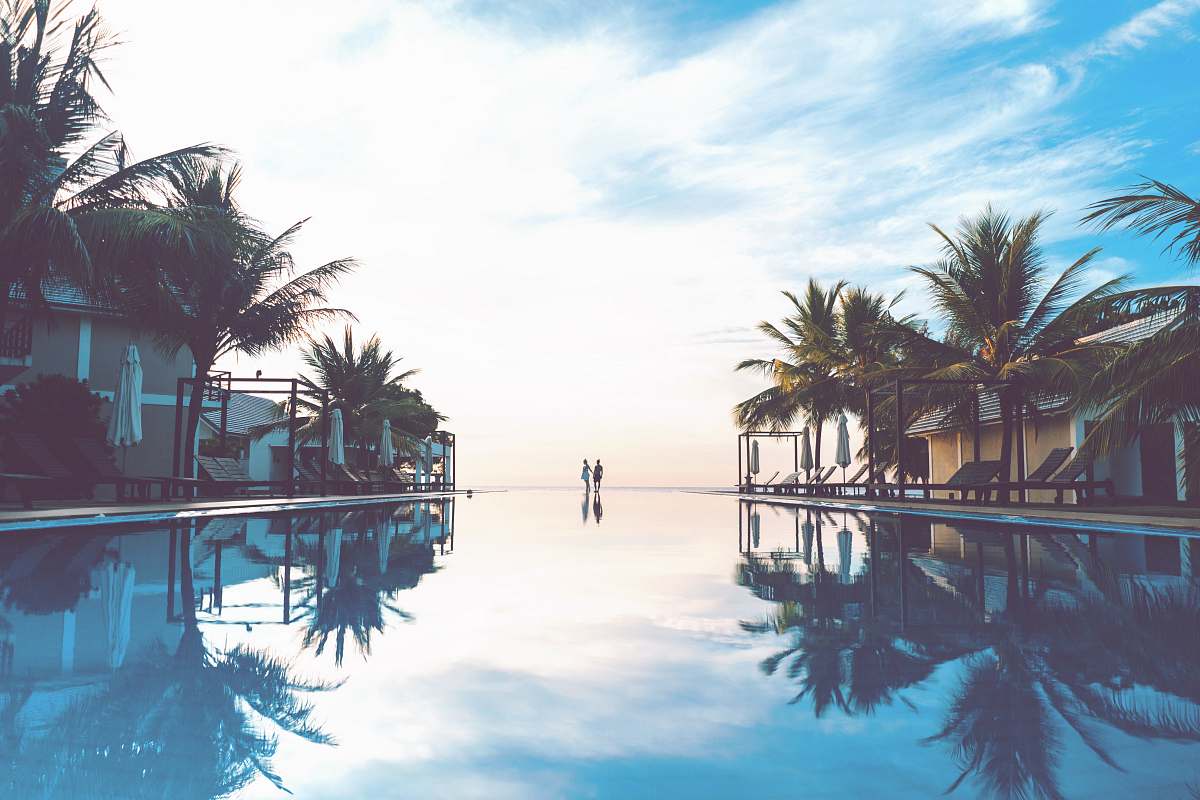 water two person standing beside swimming pool tree