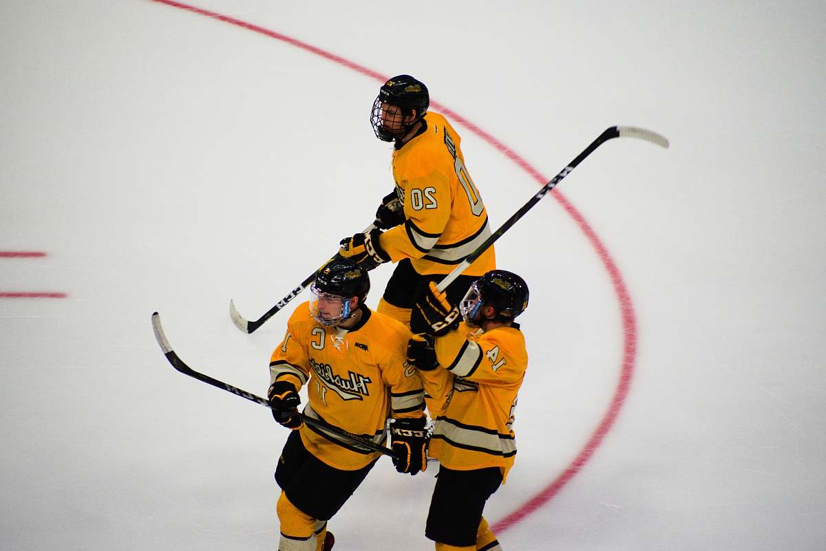 apparel three hockey players on focus photography helmet