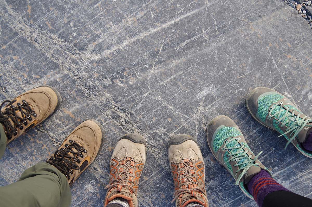 footwear three person showing sneaners shoe