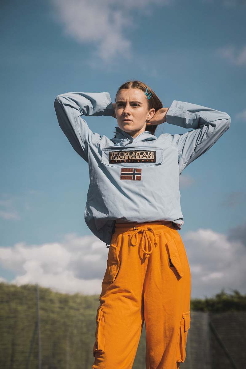 apparel woman wearing grey pullover hoodie and yellow cargo pants sleeve