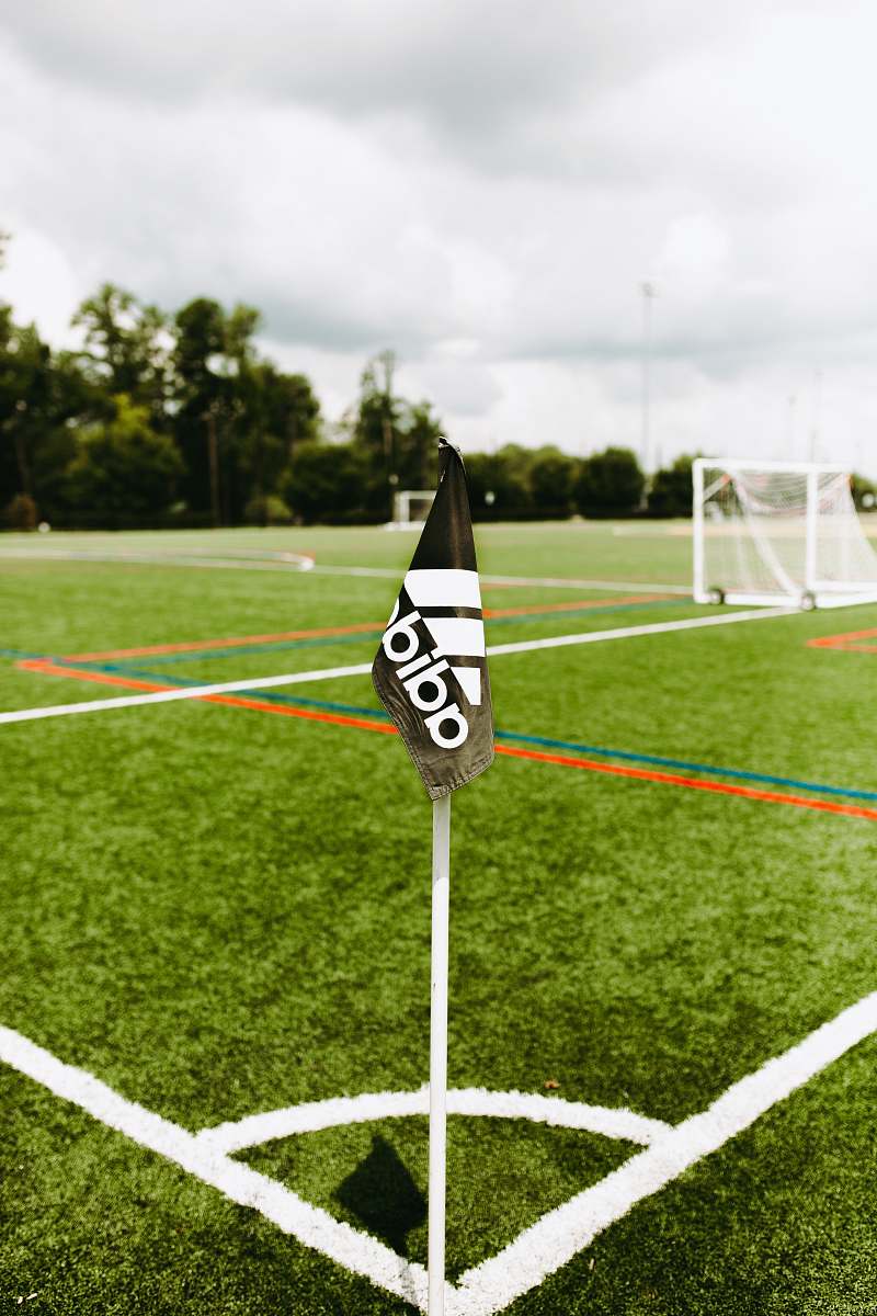 grass adidas flag on pole on soccer field plant