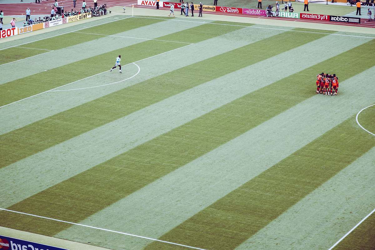 grass players making a group circle person