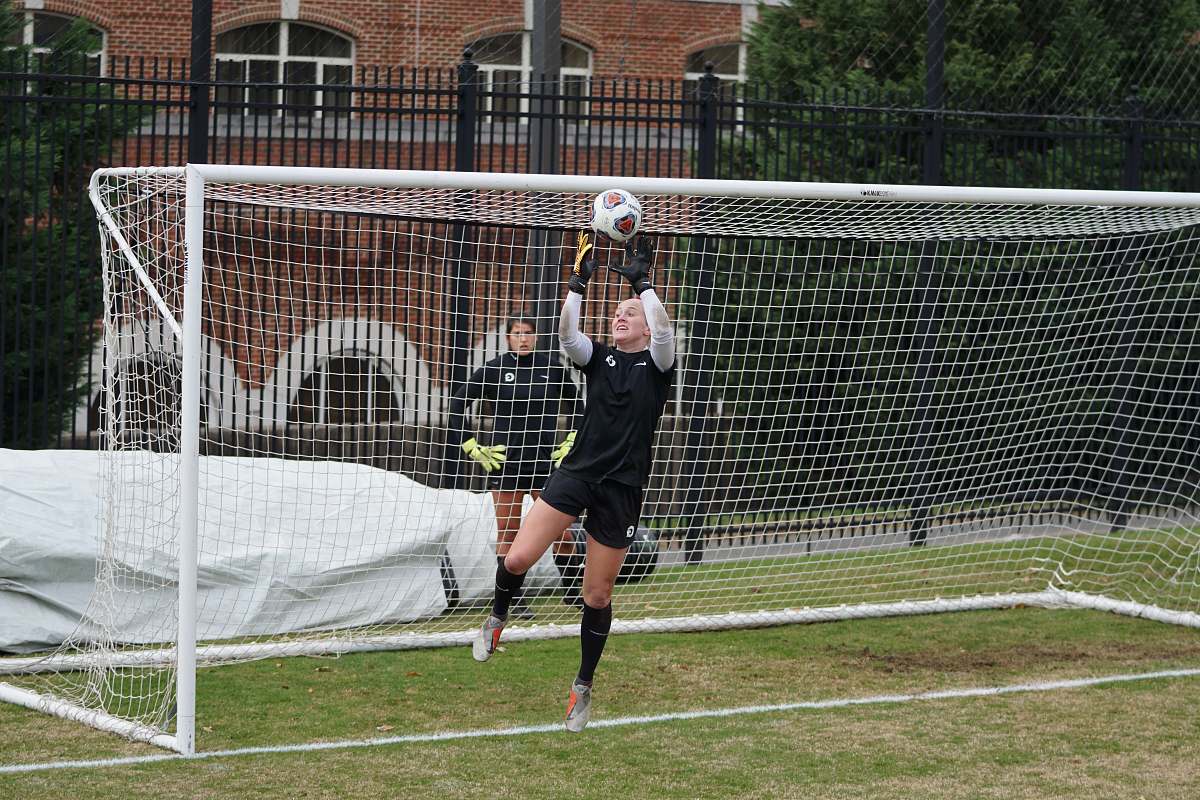 human goal keeper catching ball person