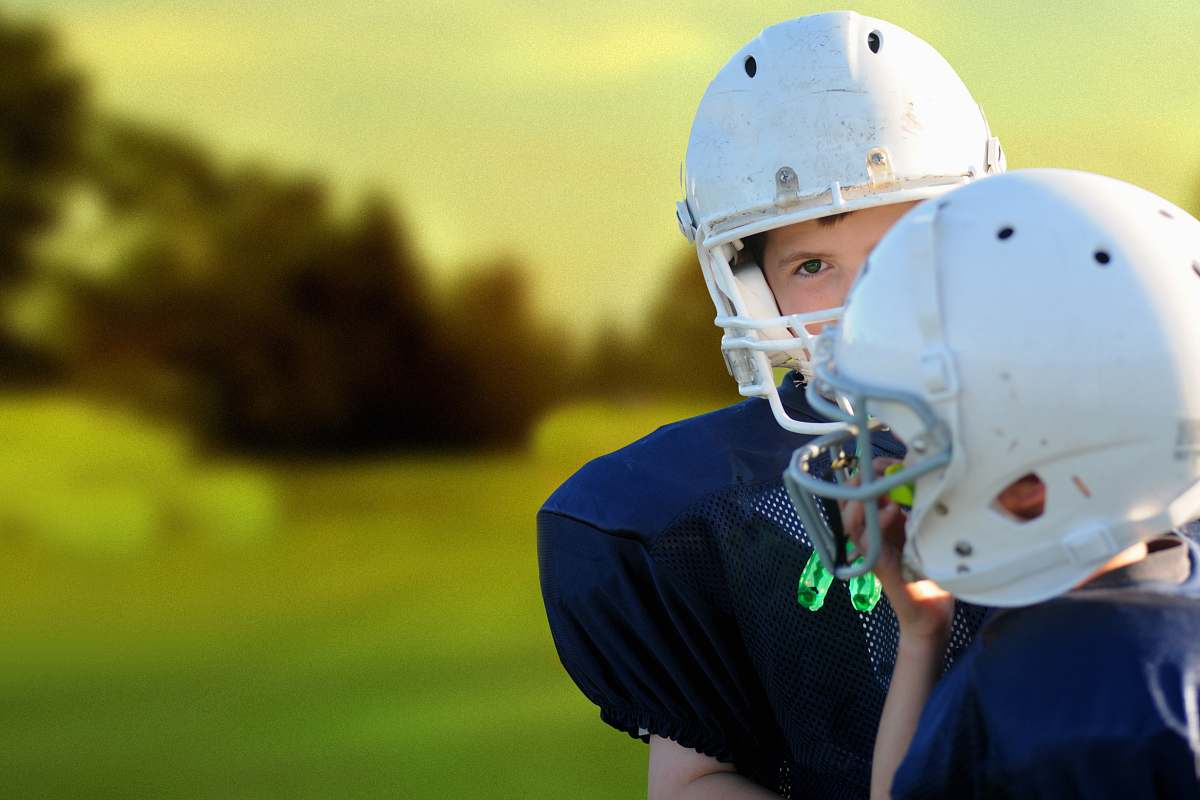 helmet selective focus photography of two football players sports