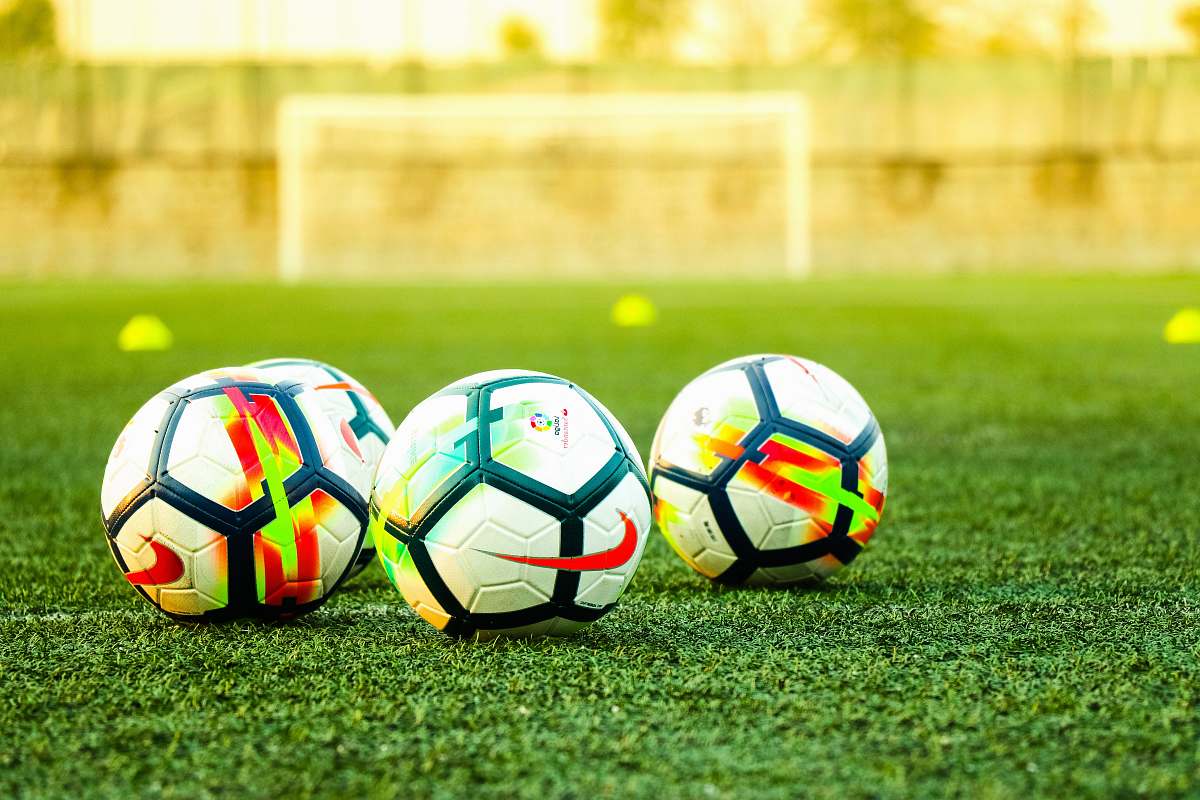 soccer three white-and-black soccer balls on field soccer ball