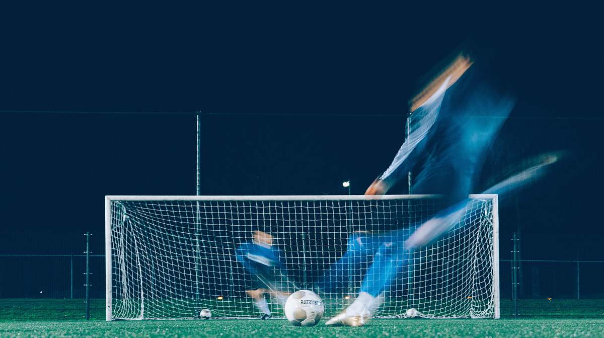sport timelapse photo of soccer player kicking ball soccer