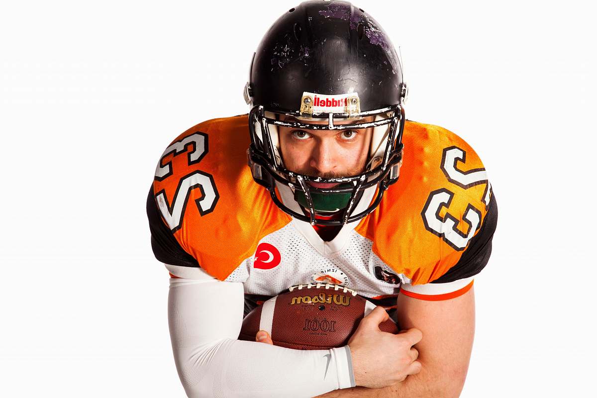 clothing man holding football apparel