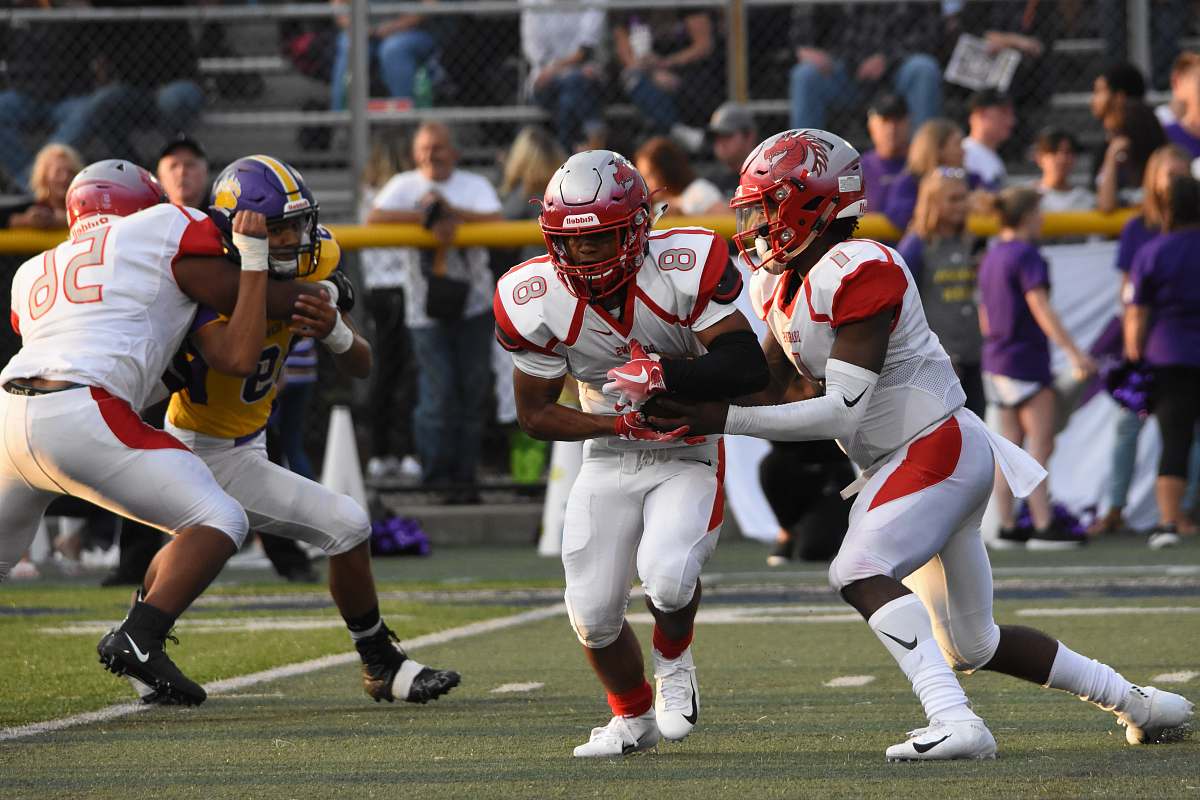 apparel men playing American football on field during daytime clothing