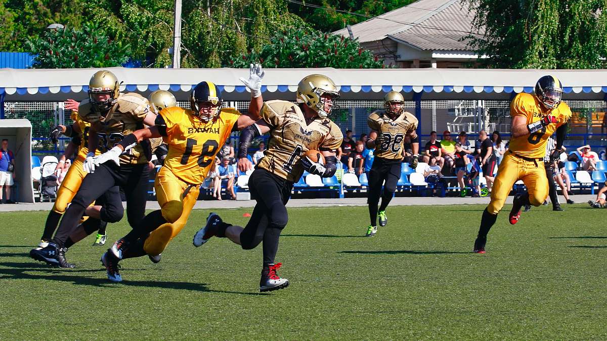 apparel men playing football at stadium clothing