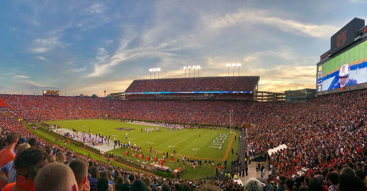 person American football stadium under clear blue sky field