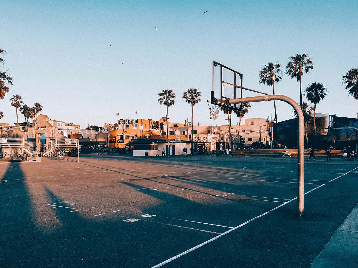 person basketball court during golden hour people