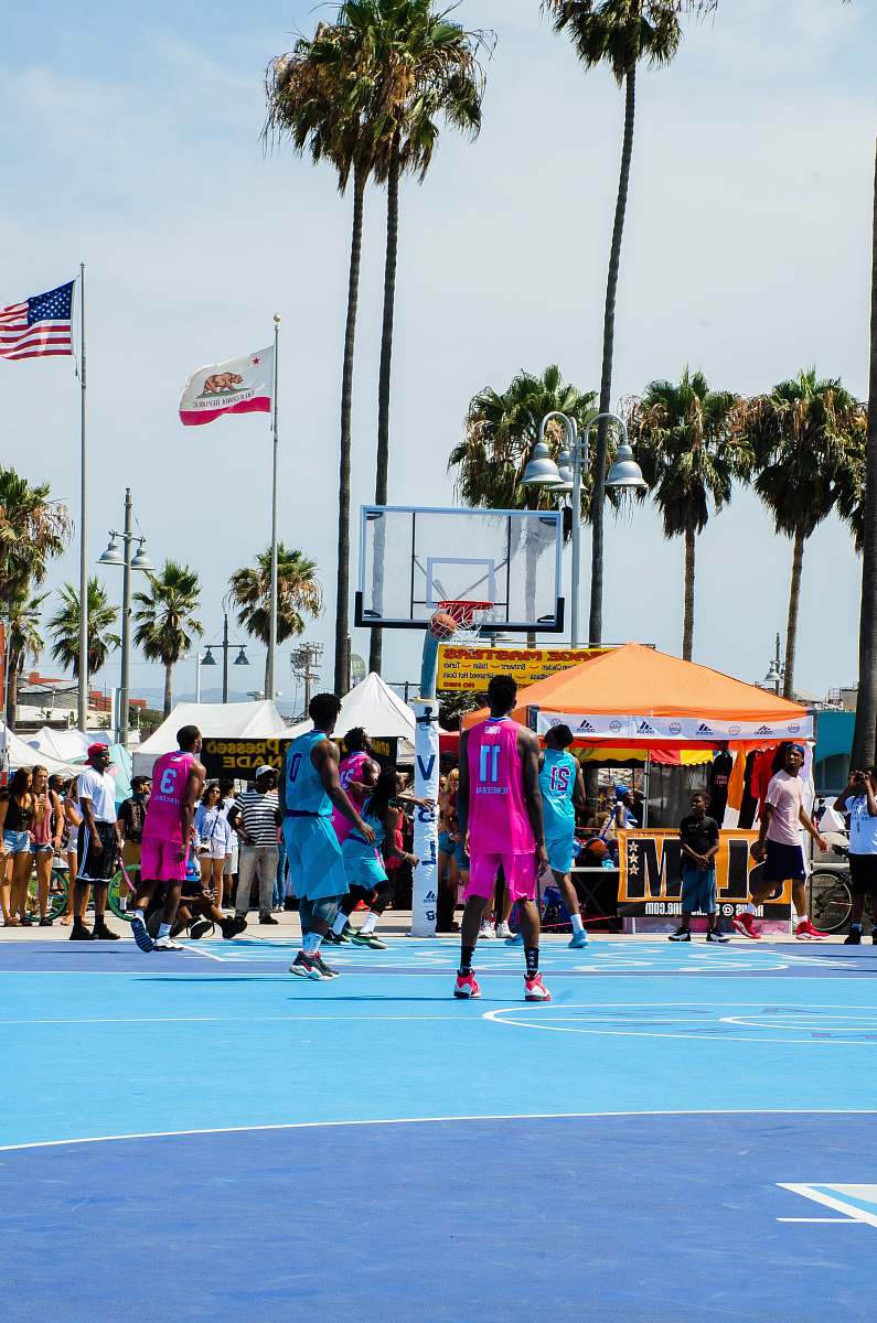 person basketball players playing during daytime flag