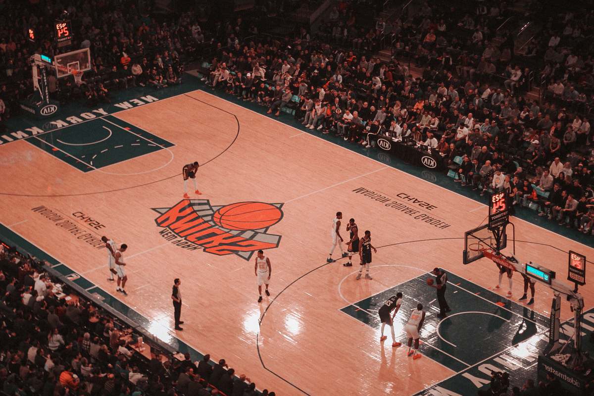 person basketball players playing on New York Knicks court people