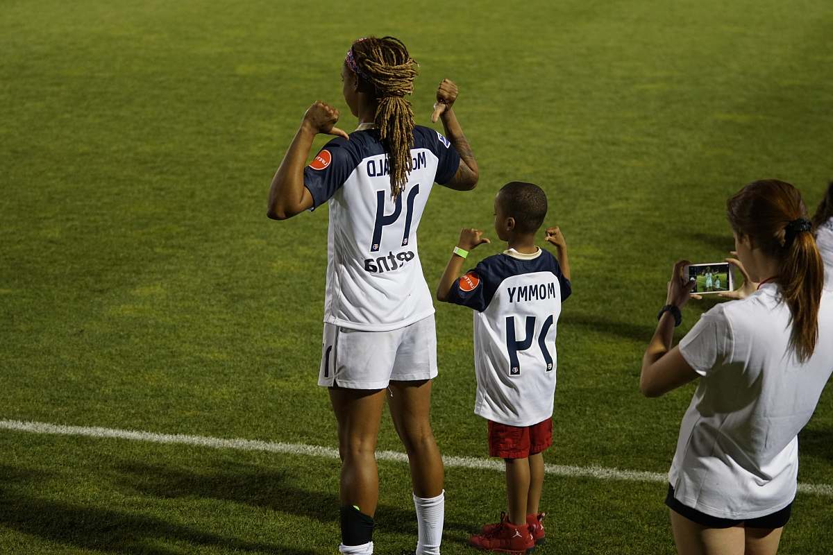 person boy and girl soccer players standing on soccer field people
