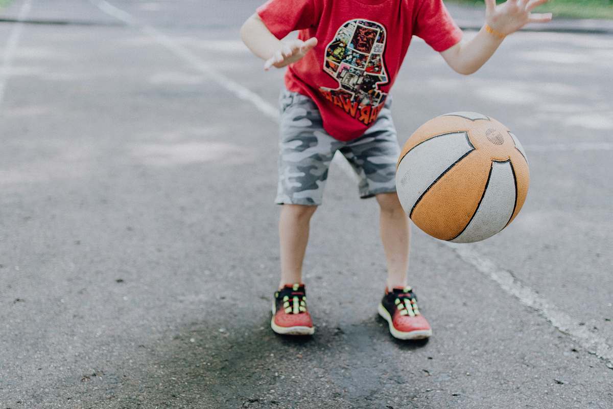 person boy playing ball at daytime sphere