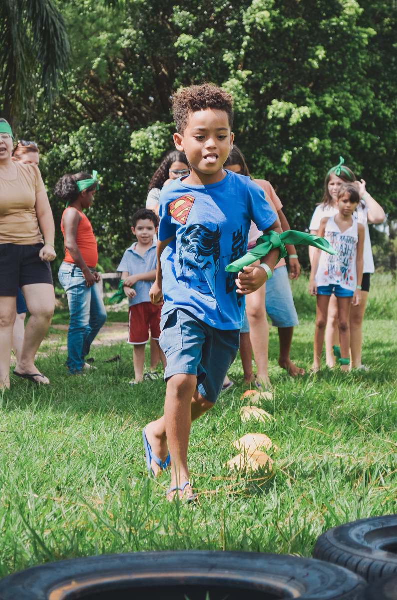 person boy running on green lawn tire