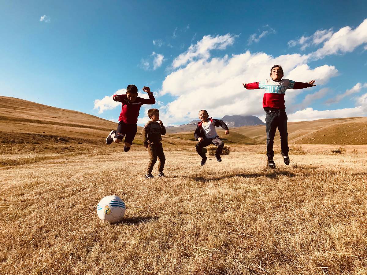 person boy's playing during daytime team