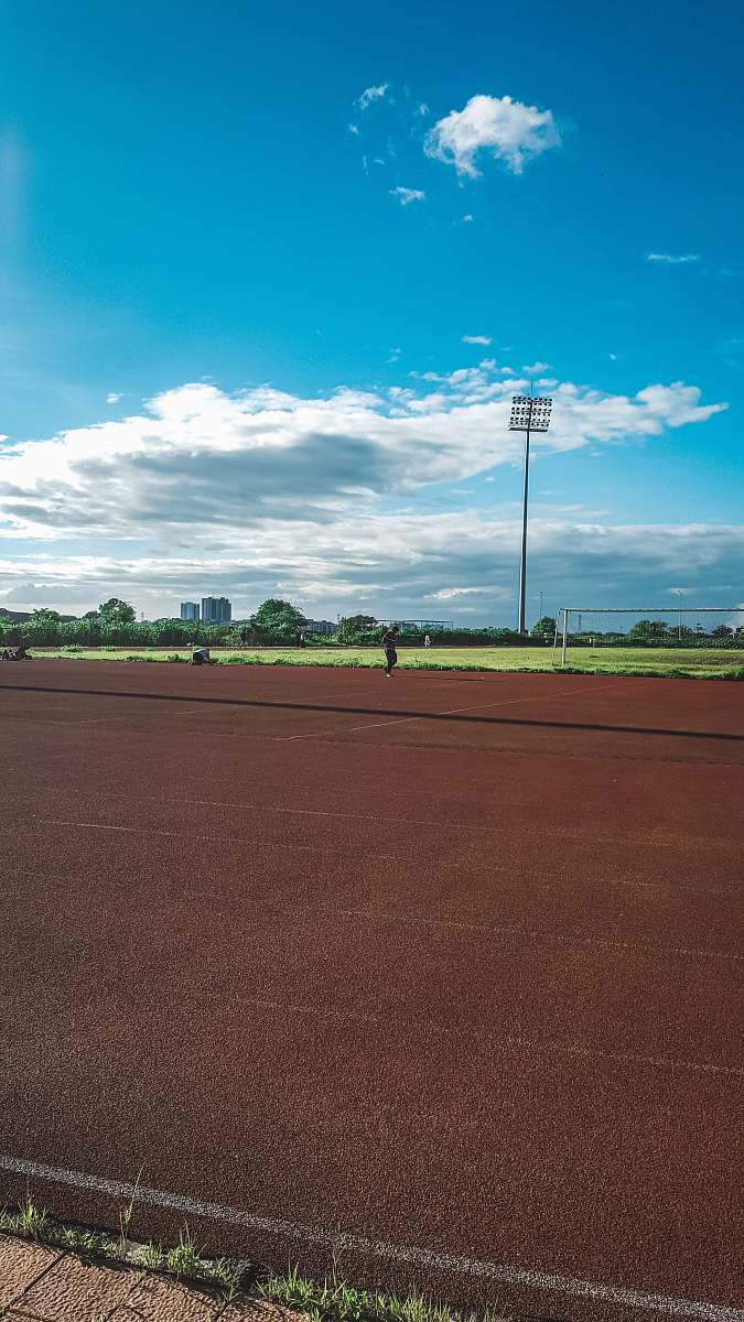 person brown and black running tracks sport