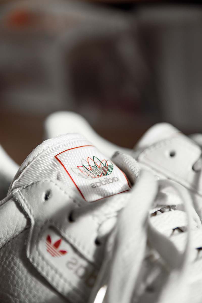 clothing closeup photo and seletive focus photography of Adidas sneakers apparel