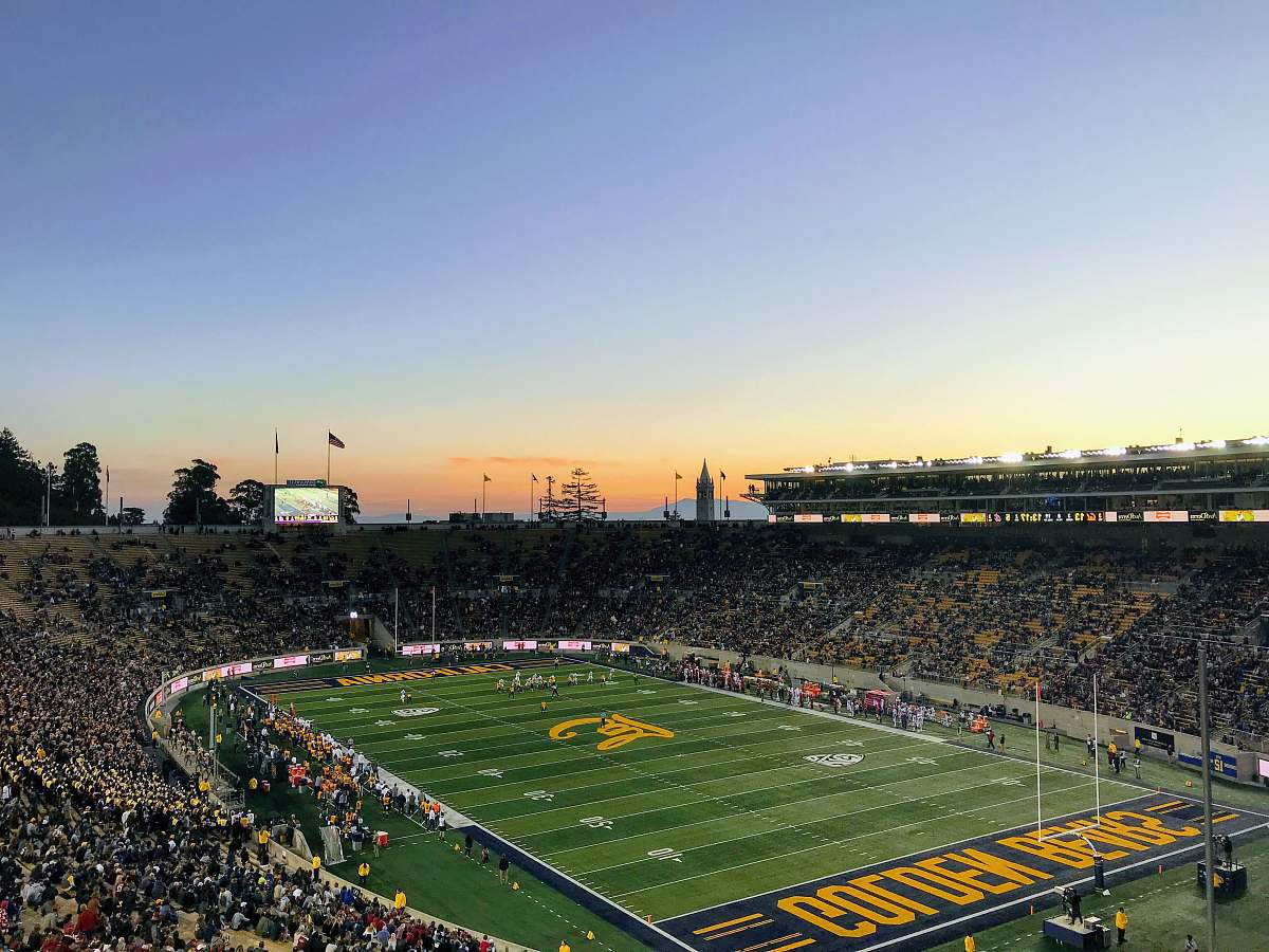 building crowd inside green Golden Bears stadium field