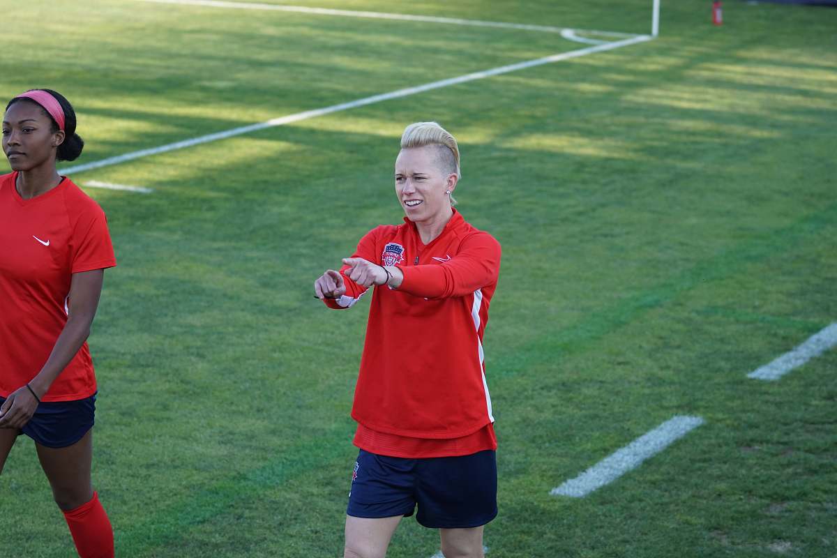 person female football player on red shirt apparel