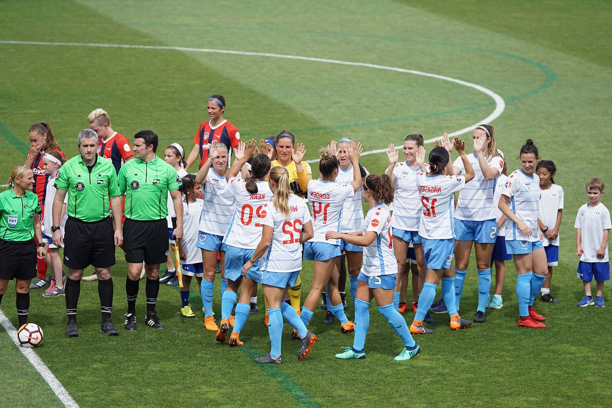 person female soccer team standing on field with officials and children people