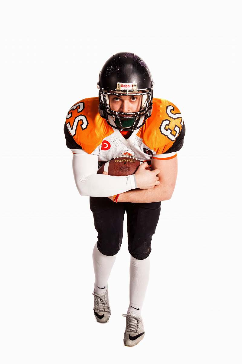 apparel football player holding ball clothing