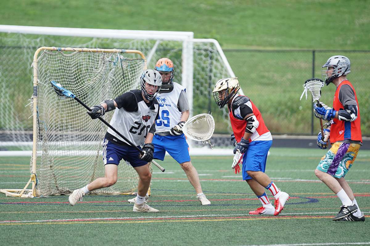 apparel four men playing lacrosse person