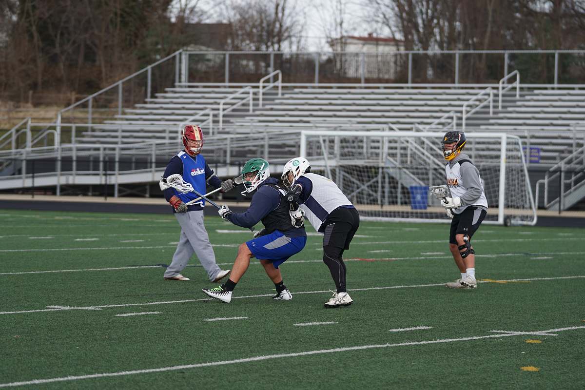 person four men playing on the field apparel