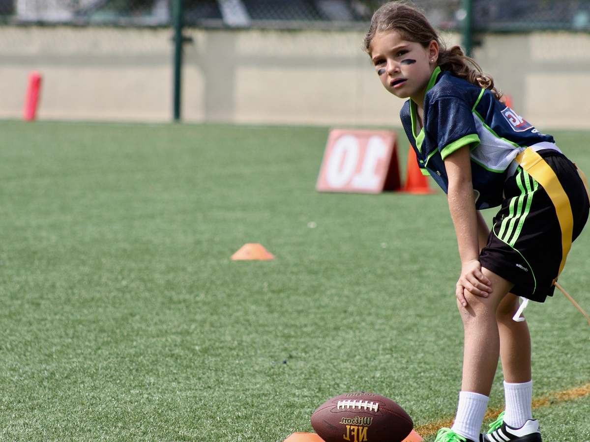 person girl standing in front of NFL football people