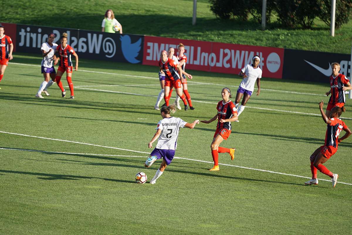 person girls playing soccer on ball field people