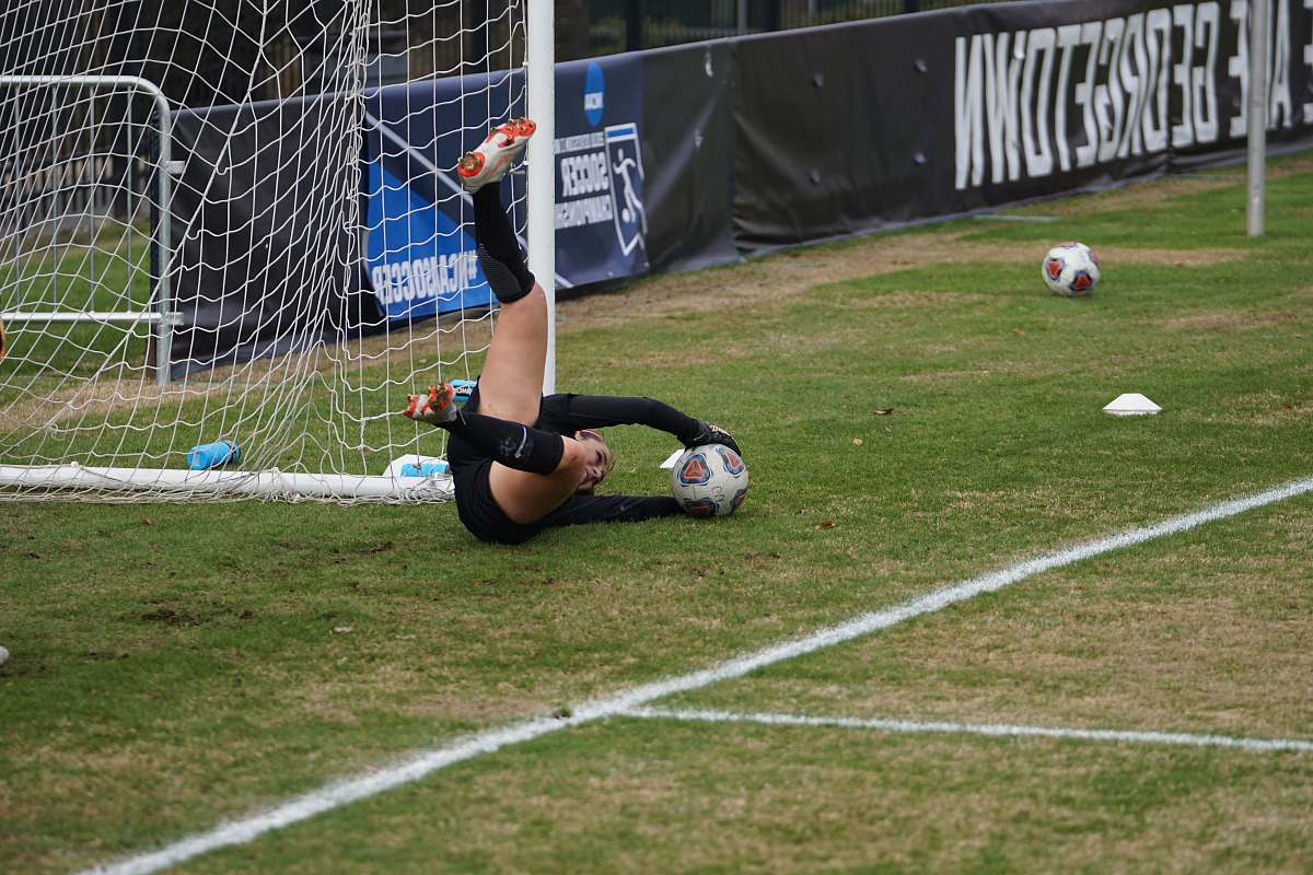 person goal keeper holding the ball soccer