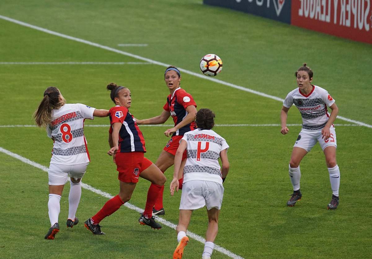 person group of female playing soccer people
