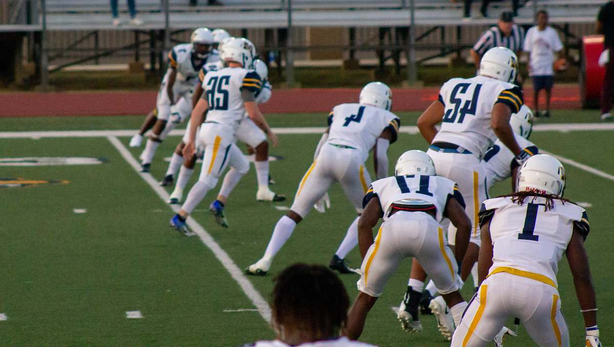 person group of men playing sprint football during daytime clothing