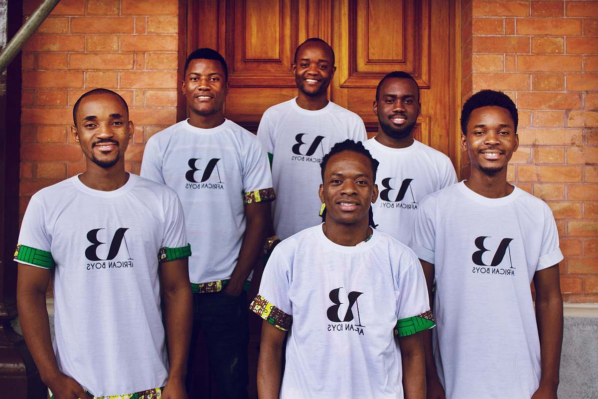 person group of men standing near brown wooden door people