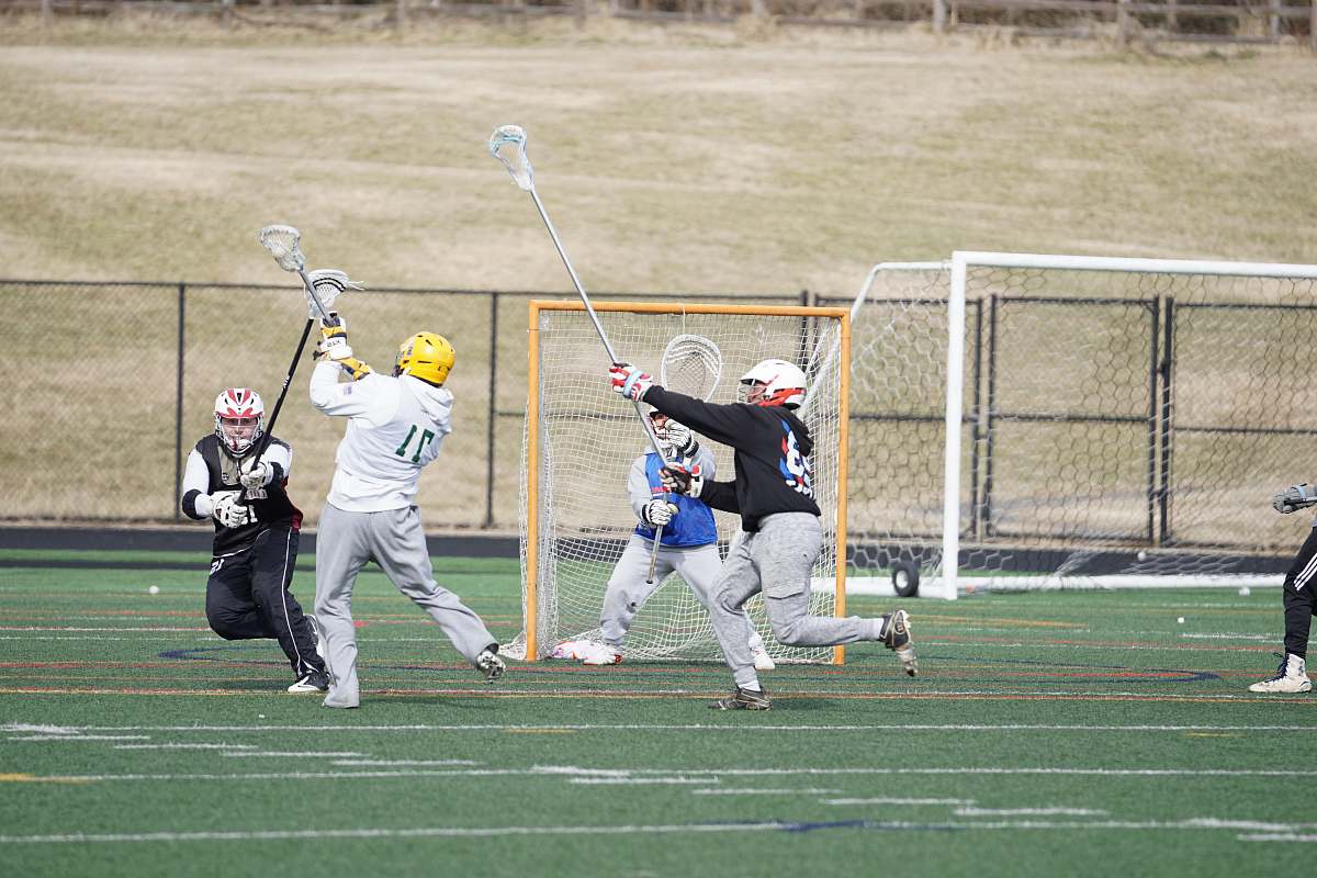 person group of men standing near goal net apparel