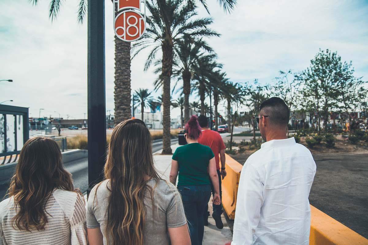 person group of people walking on a sidewalk las vegas