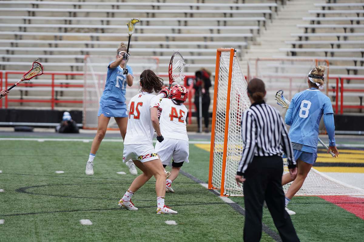 people group of woman playing lacrosse game on field person