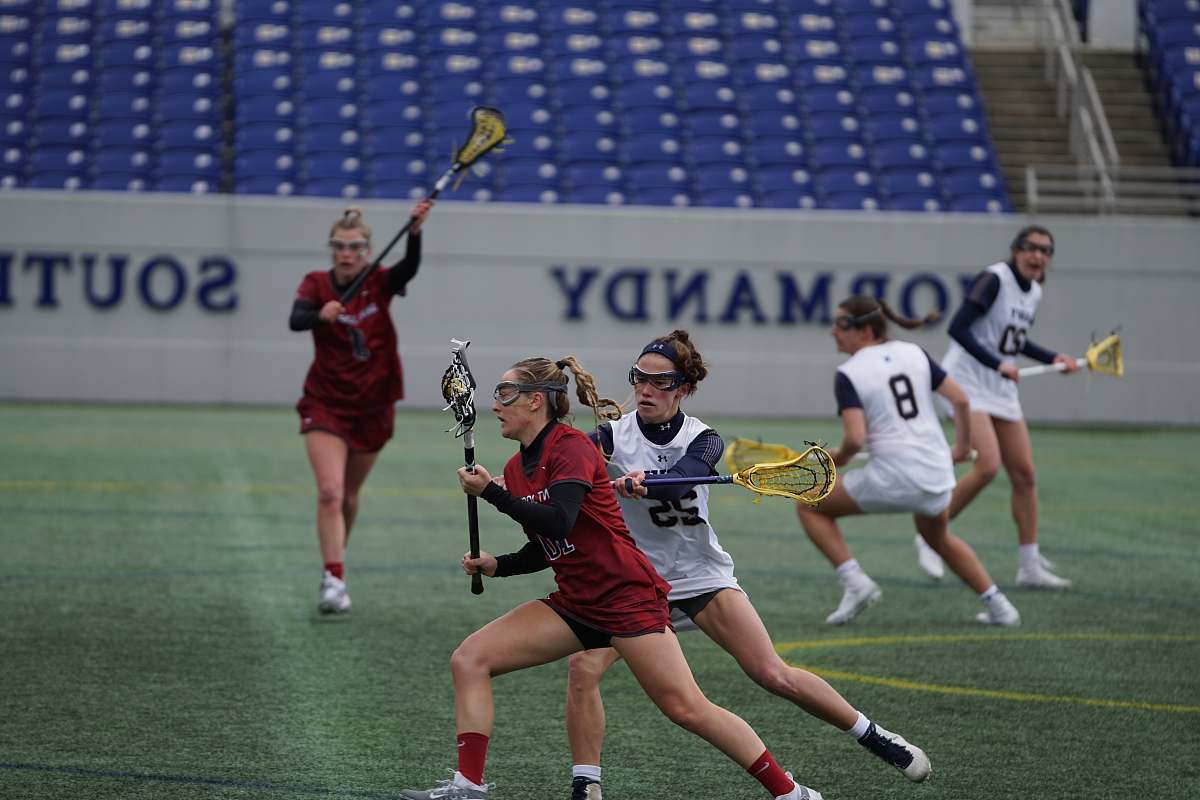 person group of women playing lacrosse people