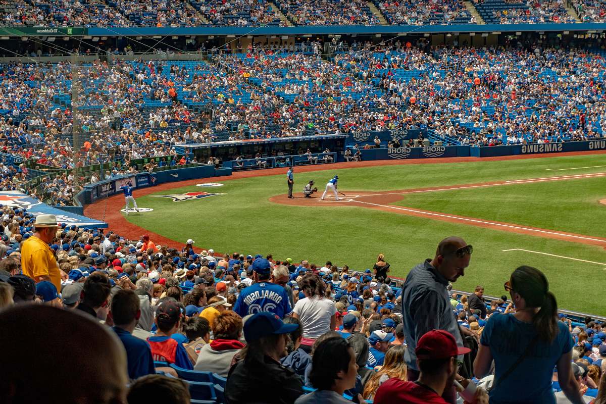person in game baseball field building
