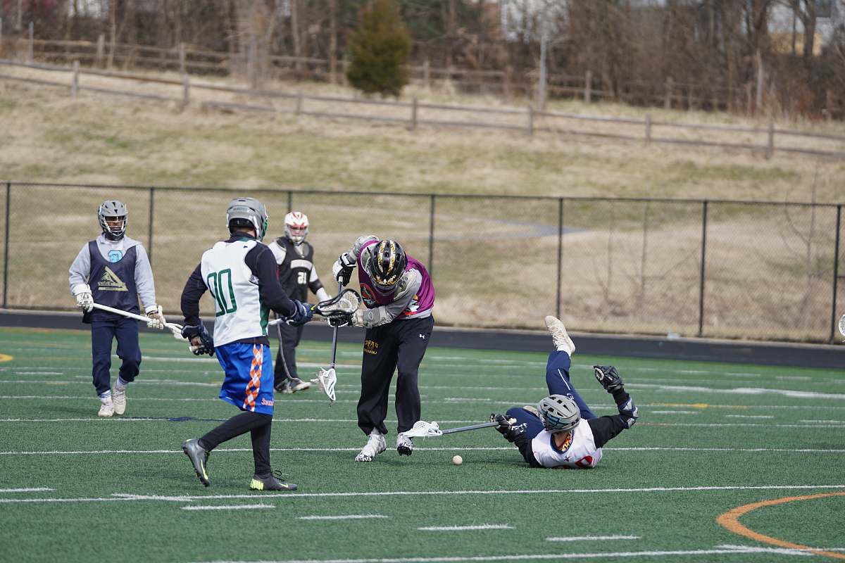 person lacrosse players on field at daytime apparel