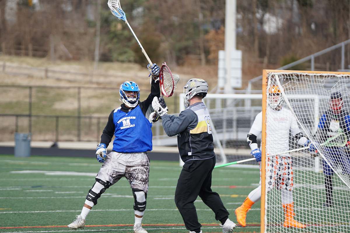apparel lacrosse players playing on field at daytime clothing